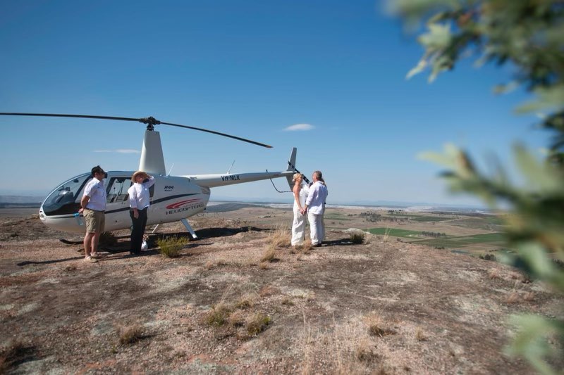 wild elopements couple next to helicopter